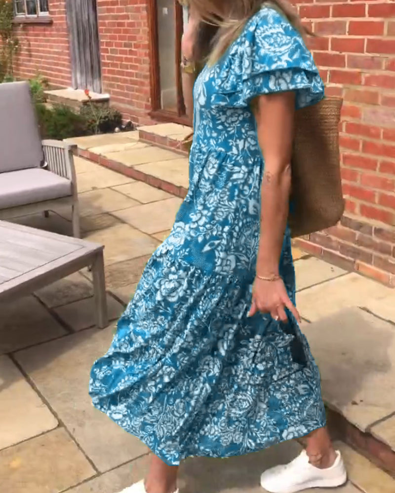 ByMoire. Lange jurk met korte mouwen en bloemenprint