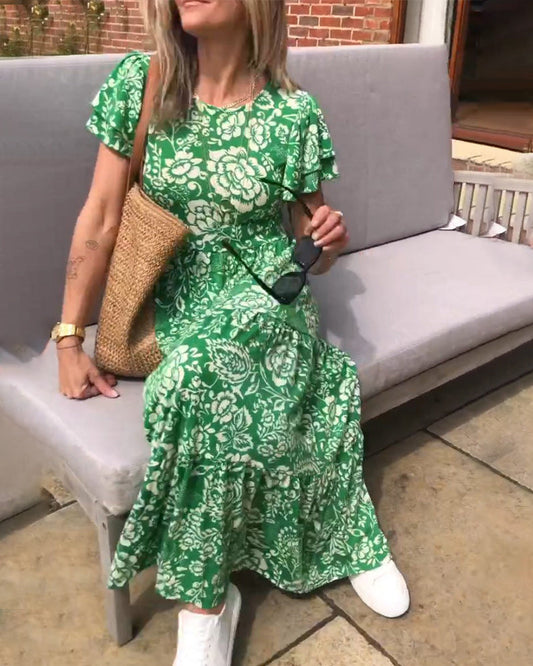 ByMoire. Lange jurk met korte mouwen en bloemenprint