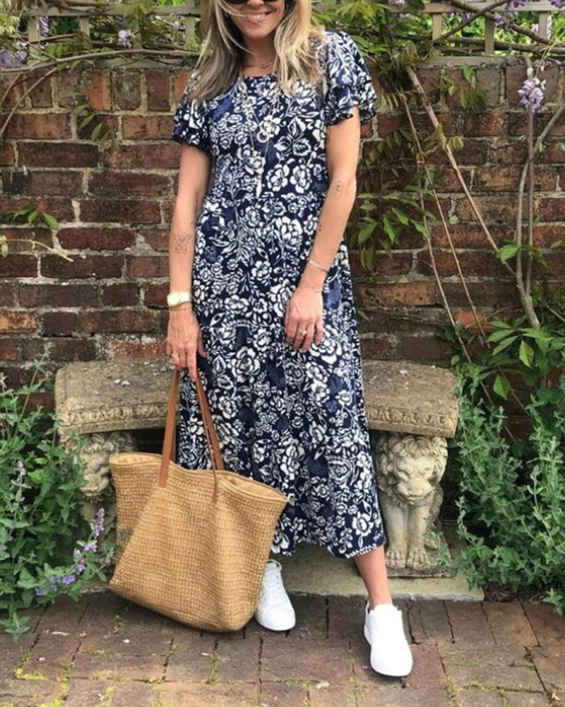 ByMoire. Lange jurk met korte mouwen en bloemenprint