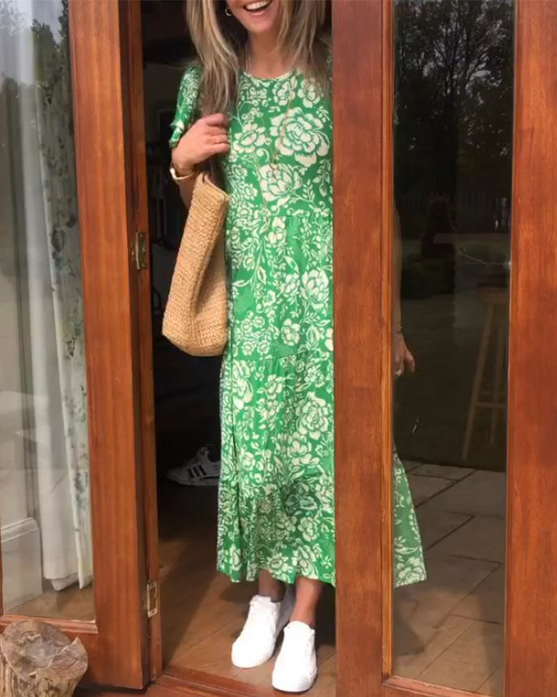 ByMoire. Lange jurk met korte mouwen en bloemenprint