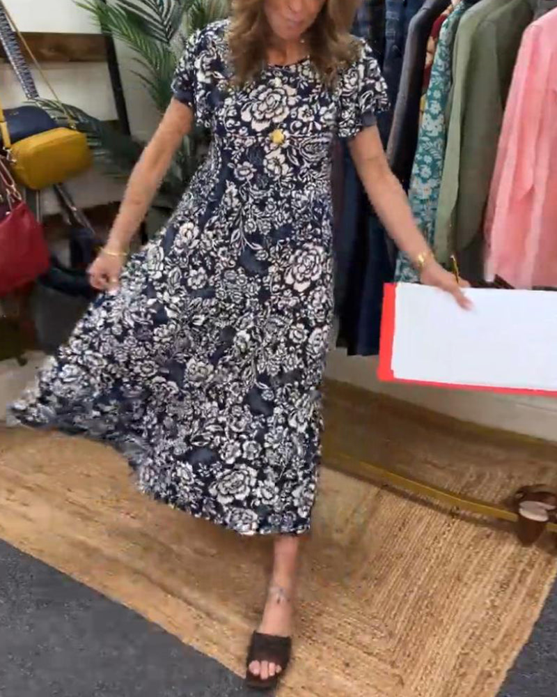 ByMoire. Lange jurk met korte mouwen en bloemenprint